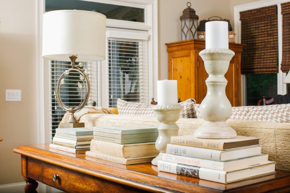 Books stacked neatly for decor in natural toned room. 